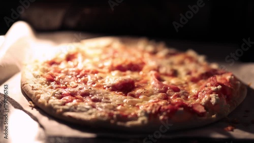 A delicious pizza baking inside a hot oven, with melting cheese bubbling on top and a golden-brown crust forming perfectly.
