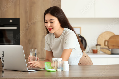 Young Asian woman with glas...