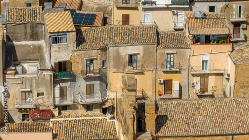 Aerial close-up of houses, buildings, and apartments in the historic center of Agrigento, Sicily, Italy. Traditional southern Italian homes.