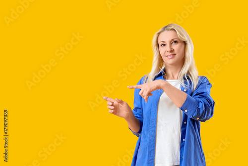 Mature blonde woman pointin...