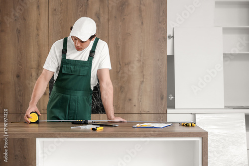 Male worker measuring table...