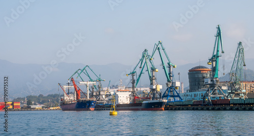 Industrial port with cargo ships, cranes, containers and freight trains. Global logistics, maritime trade, shipping industry and infrastructure.