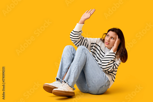 Scared young woman sitting ...