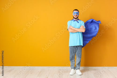 Young man dressed as superh...