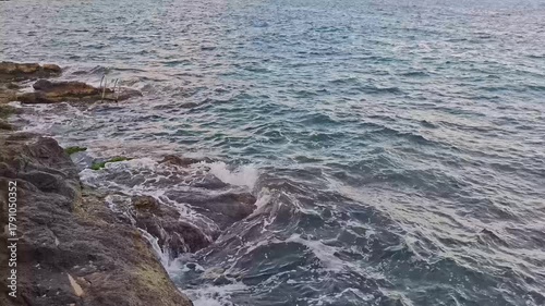 Abandoned ladder in between the rocks going into the sea in Malta, Valletta