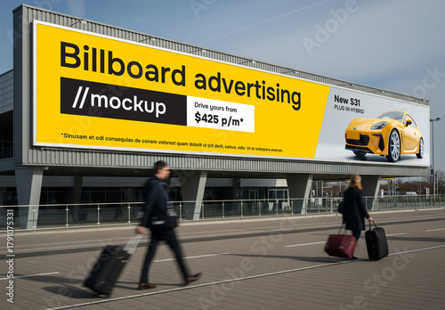 A very long billboard on the side of an airport terminal or station