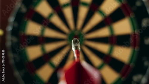 Immersive point of view shot of a red dart flying through the air and hitting the bullseye in the center of a dartboard, representing the concept of precision, success, and achieving goals