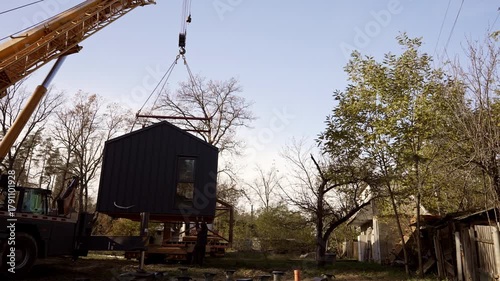 Workers move a modular home.