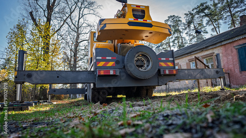 The truck crane is in the process of being prepared for work.
