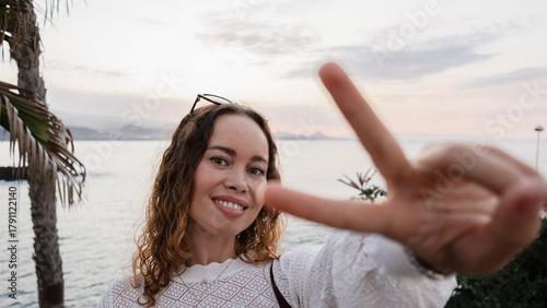 Woman making selfie with hand gesture on Canary Islands holiday