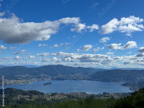 Panoramic view of the San Simón bay and surrounding mountains under a blue sky, Vilaboa, Galicia, Spain, October 2024