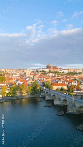Discover the stunning views of Charles Bridge and Prague Castle as the morning sunlight bathes the city. Enjoy the vibrant rooftops and the peaceful Vltava River in this picturesque setting.