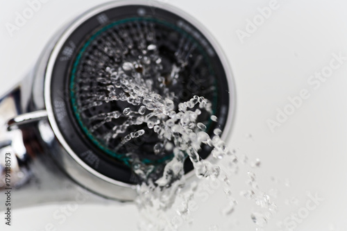 Modern Chrome Faucet Dispensing Droplets Water with Motion Blur