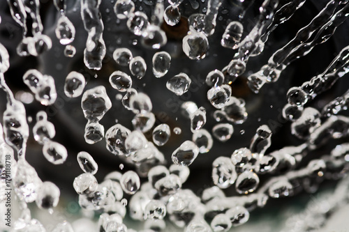 Drops levitate. Frozen Icicles Hanging Close-Up in Winter Macro Shot