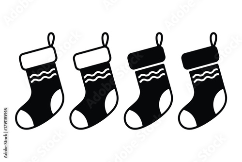 Four black Christmas stockings with white cuffs and wavy patterns are displayed side-by-side.