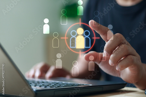 Digital marketing and customer targeting concept. Person using a laptop with virtual icons of audience focus. Ideal for illustrating online advertising, business analytics and marketing strategy.