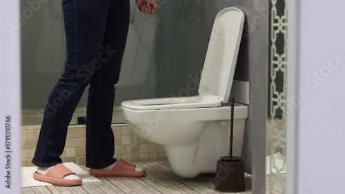 Cleaning the toilet with a brush. Close-up of a woman's hand cleaning the toilet with a brush. Hygiene concept. Checking the cleanliness of the toilet