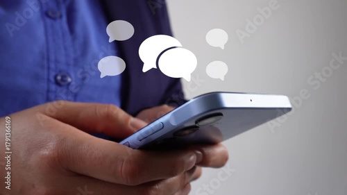 Online chat. Female corporate leader using her cell phone with an animation of several speech bubbles.