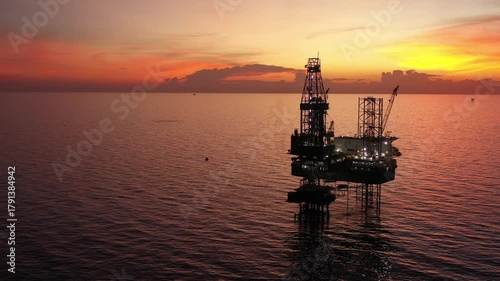 Aerial view of offshore jack up rig and offshore platform during sunset for oil and gas exploration and production. 

