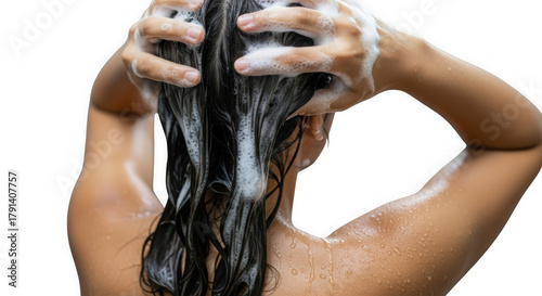 Close-up from behind of hands massaging shampoo into long dark wet hair. Intimate shot of hair washing with lather and suds for refreshment. Sensory experience of cleansing long dark hair