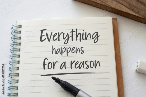 A notebook with inspirational text and a marker