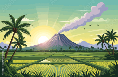 Tropical rice terraces beneath a smoking volcano at sunrise