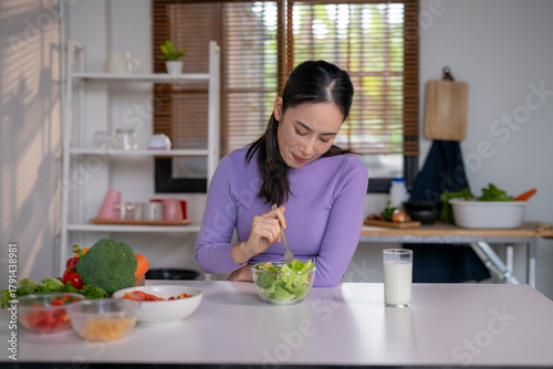 Asian woman eating fresh salad for healthy diet