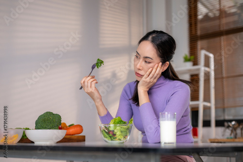 Woman feeling unhappy diet eating healthy salad with vegetables