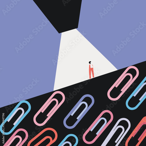 Person standing under a spotlight with colorful paperclips