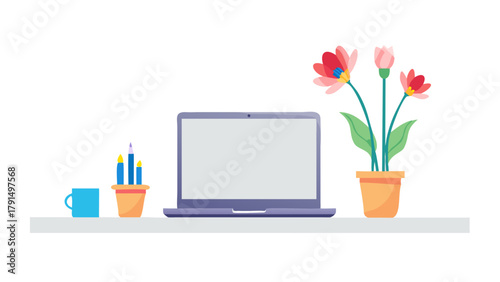 Minimalist workspace with laptop and vase of fresh flowers on a desk