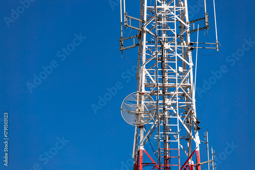 satellite dish antenna on high electrical pole wireless network telecom communication tower for cyberspace cellular digital broadcast modern television technology with clear blue sky