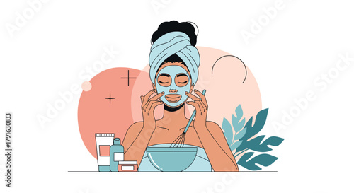 Young woman with towel on head applies a face mask with her hands.