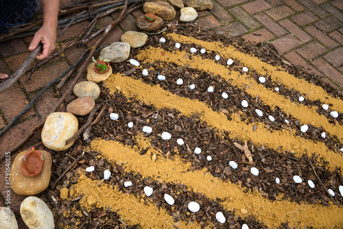 Photos Creating a mandala with rocks, sand, earth and ochre - horizontal