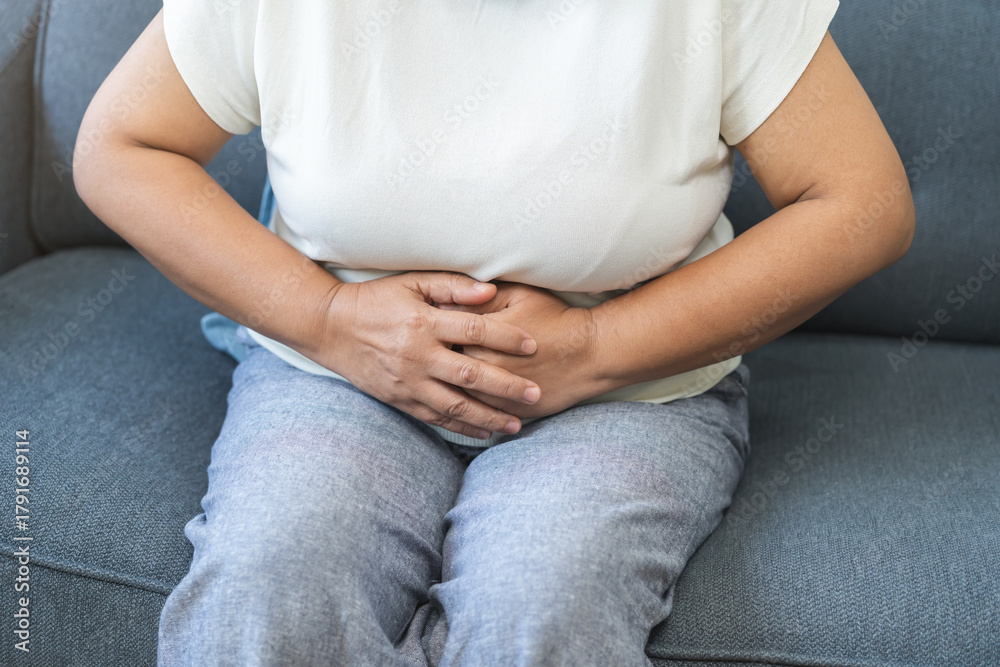 Φωτογραφία Sick asian senior woman in pain, hand holding belly, stomach pain from food poisoning, older hurt abdomen ache and digestive problem, gastritis or diarrhea