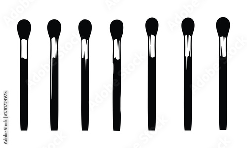 Row of black matchsticks, fire starting tools, and ignition elements.