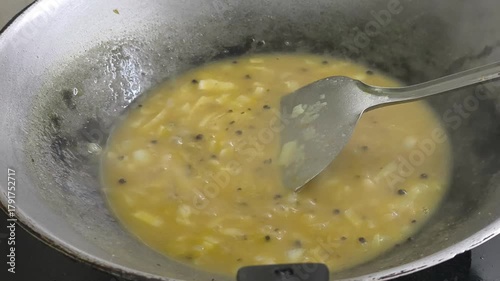 A chef is expertly preparing black pepper sauce, incorporating various ingredients into a pan. The mixture is heated and cooked, resulting in a rich and flavorful culinary creation.