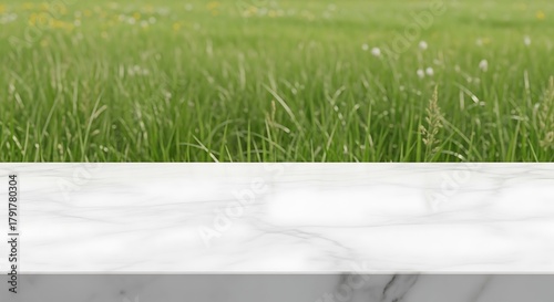 Marble table top with blurred green grass field in the background