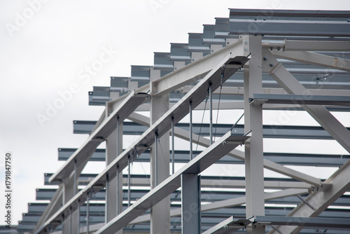 Bild auf Leinwand Close-up of construction of modern steel structure framework at building site