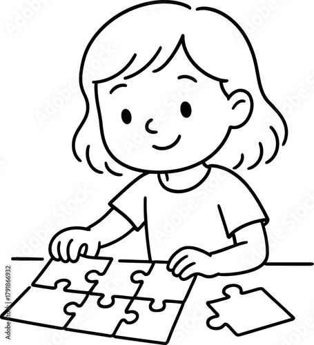Young girl concentrates on completing a jigsaw puzzle