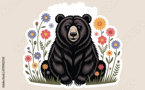 A black bear sits peacefully surrounded by colorful wildflowers in a meadow.