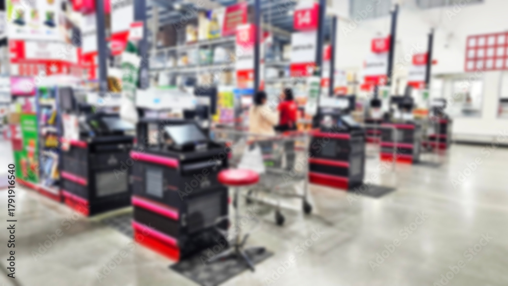 Obraz premium Checkout Lines in Supermarket: A blurry interior shot showcasing several checkout lines in a bustling supermarket, conveying a sense of customer traffic.