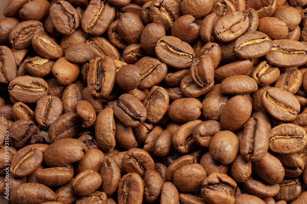 Naklejka premium Full frame of freshly roasted coffee beans.