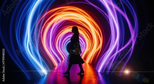 Silhouette of woman walk through colorful immersive light installation