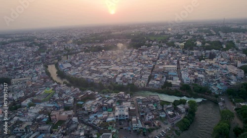 Aerial view of the Cooum River winding through Chennai City, Tamil Nadu. This short but significant river flows toward the Bay of Bengal, showcasing urban landscapes and waterway scenery.