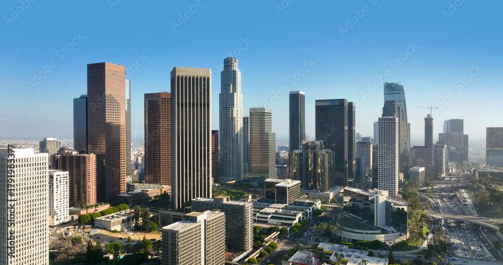 Obraz premium Travel photo of downtown LA city skyline. American city. Los Angeles financial district with skyscrapers. Aerial panorama of the LA city skyline and streets of California. City view of Los Angeles.