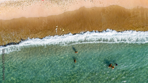 Fototapeta Naklejka Na Ścianę i Meble -  Aerial drone view of sandy beach and turquoise sea waves with people sunbathing, swimming and relaxing, holiday vacation concept, Antalya Konyaalti beach, Turkey