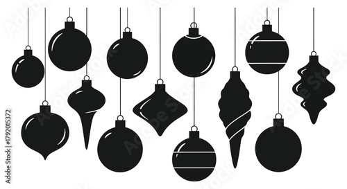 Collection of various black christmas tree ornaments hanging against a white background