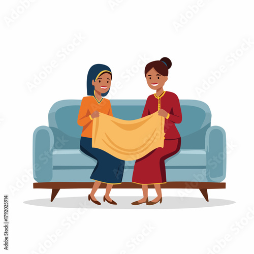 Two smiling women discussing a yellow fabric on a couch, possibly for sewing or home decor