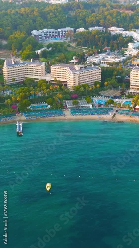 Vertical video. Avsallar, Alanya, Turkey. Aerial evening view of a secluded bay with private beaches surrounded by resorts.. Aerial View. Rich colors