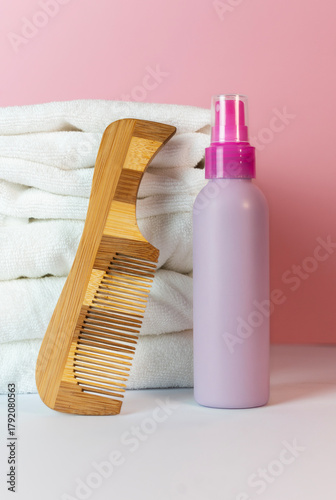 Plastic bottle for spraying hair with towels and comb